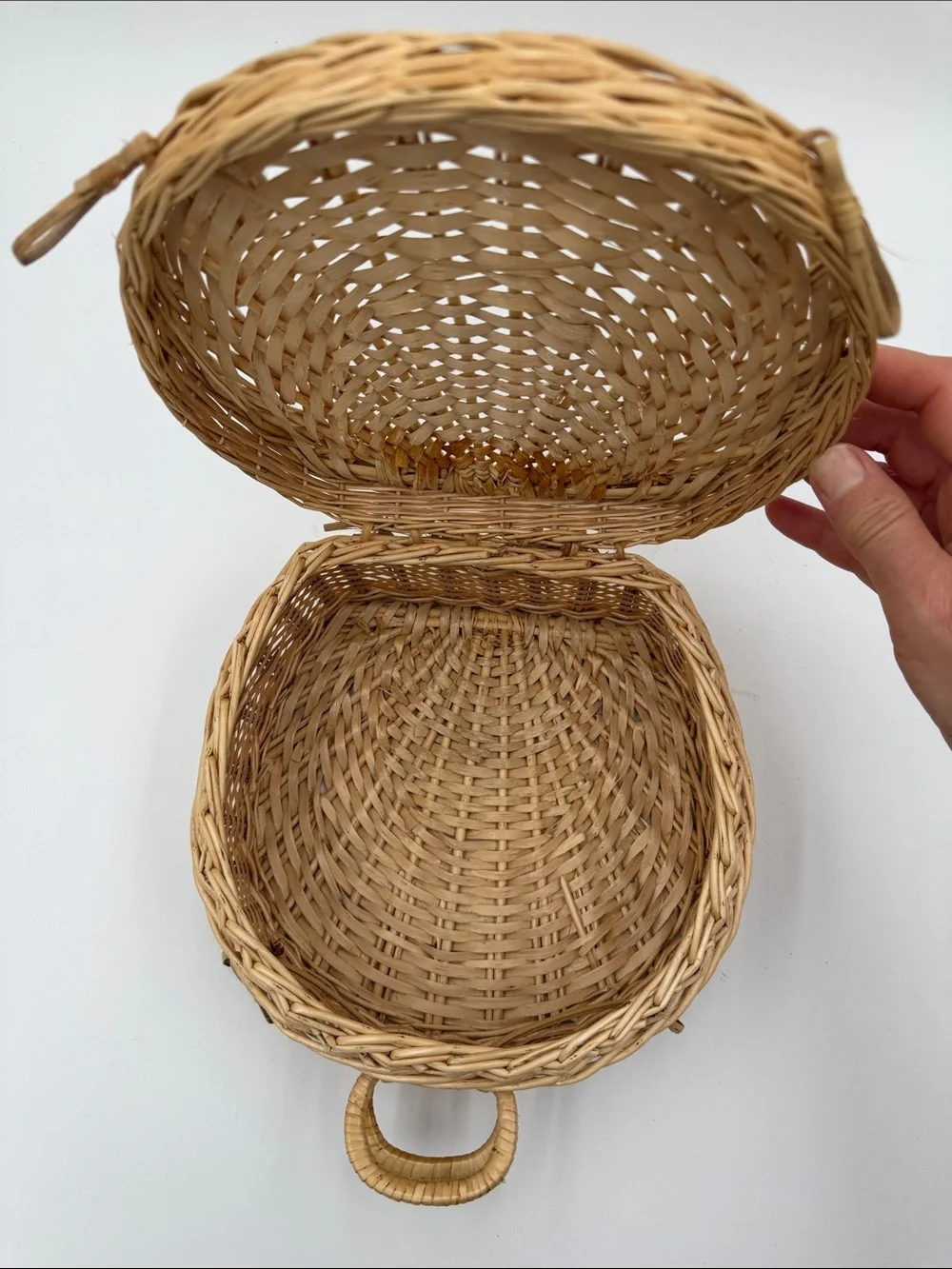 A Cute, charming vintage shell-shaped rattan storage basket with a front handle.